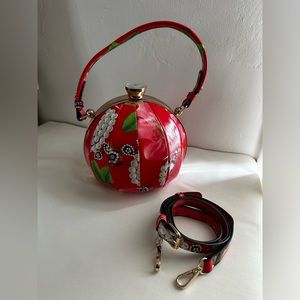 Alyssa Bags Red print ball purse with crossbody strap.